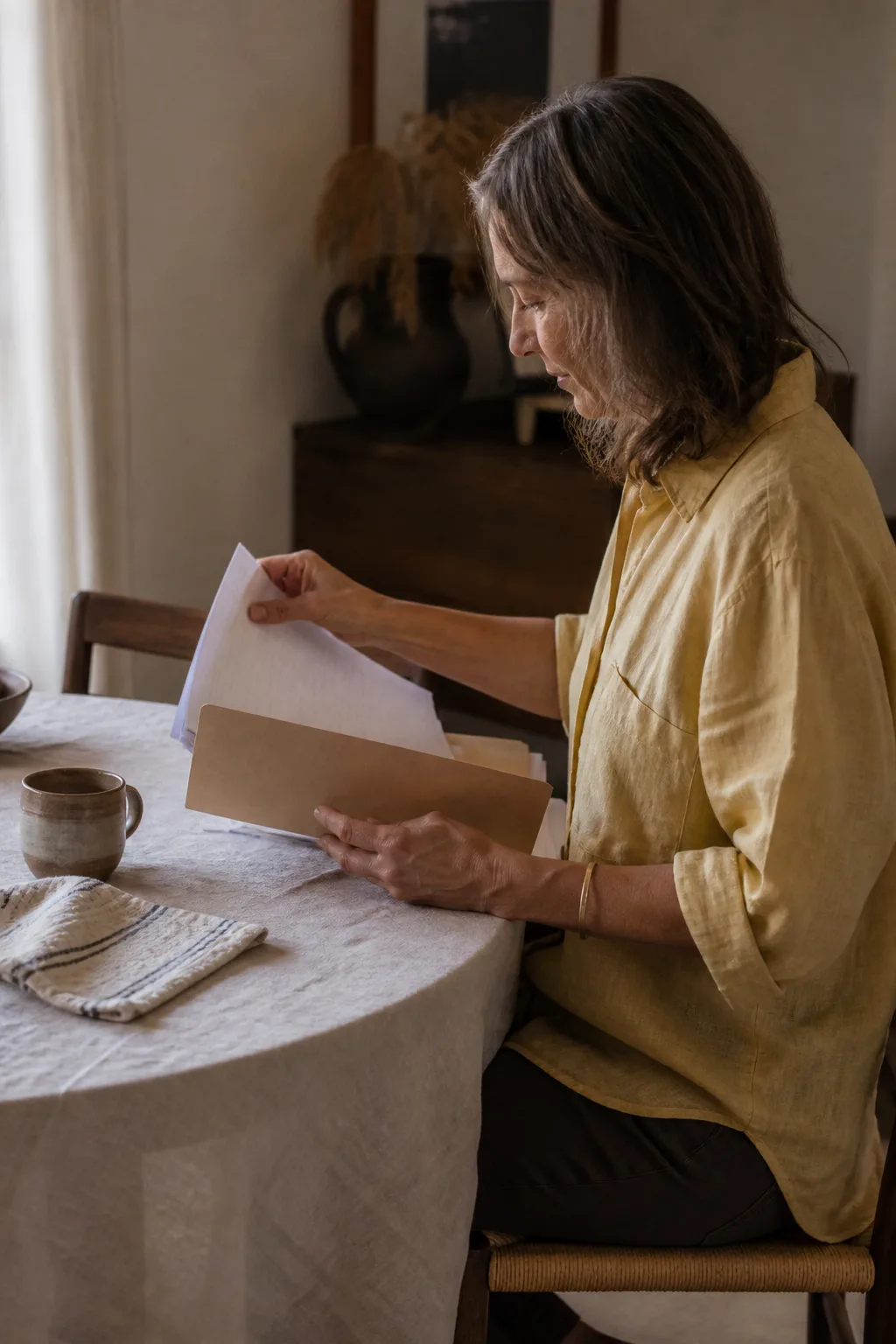 A woman reviewing family correspondence at home